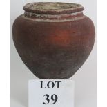 An ancient ceramic jar, possibly Roman Eastern Holy Land, of squat balluster form. Diameter 18cm.
