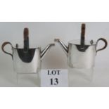 A pair of antique electroplated watering can water jugs by Hukin and Heath in the style of Dr