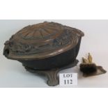 A heavy antique cast iron clam style coal scuttle with ornate lid and two brass fire accessories.