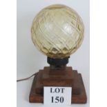 An Art Deco style handmade globe lamp with diamond patterned glass shade and three step oak base.