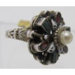 An Austro-Hungarian white metal dress ring, set with three emeralds, nine citrines and centre pearl,