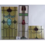 Three Edwardian Art Nouveau stained glass panels one in the style of Rennie Mackintosh, largest 80cm