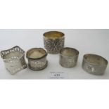 An Indian silver napkin ring decorated with deity and four other hallmarked silver napkin rings,