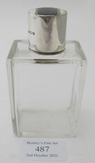 A rectangular glass scent bottle with black & white enamelling on the silver top, Birmingham 1930.