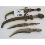 Four Eastern daggers, all with curved blades and matching metal scabbards. Longest 43cm. Condition