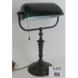 A heavy quality brass 1930s banker's lamp with replacement emeralite dark green glass shade.