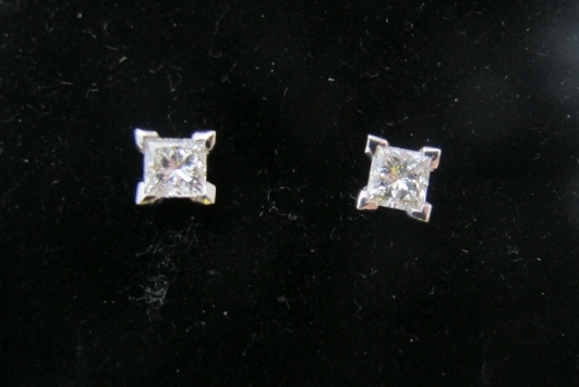 A pair of 18ct white gold princess cut diamond four claw stud earrings, diamonds approx 0.74cts,