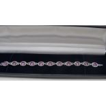 A fine 18ct white gold pink sapphire and diamond oval line bracelet, sapphires approx 10.15cts,