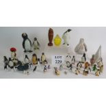 A large collection of penguin figures including glass, ceramic, stone, metal etc. (qty). Condition