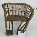 An Edwardian wicker canework child's vintage bicycle carry seat with wooden seat and footrests.