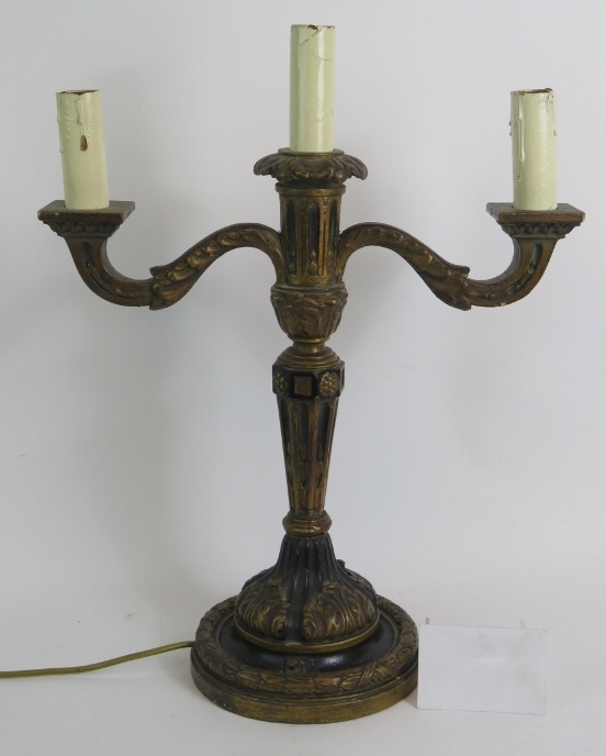 An early 20th Century Gothic style carved wood and gilded gesso three branch electric candelabra