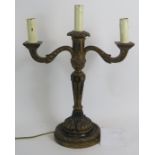 An early 20th Century Gothic style carved wood and gilded gesso three branch electric candelabra