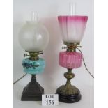 Two turn of the century oil lamps with etched glass shades and glass reservoirs later converted to