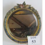 A circular early 20th Century Barbola mirror with floral moulding and bevelled glass. Diameter 30cm.
