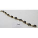 Smokey quartz bracelet, 7.5" length, 10mm x 8mm oval brilliant cut stones, approx 12 grams.