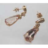 A large pair of 18ct rose gold morganite & diamond chandelier style drop earrings. Faceted pear