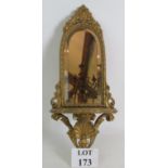 An ornate 19th Century gilt and gesso bracket mirror with Rococo shell support and bevelled