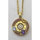 An 18ct gold Bulgari ruby, diamond and gem set pendant, on an 18ct gold chain.
