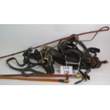 A quantity of carriage horse tack including collar and bridle plus a driving whip and two antler