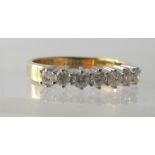 An 18ct white and yellow gold seven stone diamond ring, round brilliant cut diamonds 0.50cts, colour