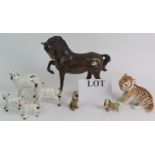 A Beswick Pottery horse, a Beswick Pottery sheep and three lambs, two Disney wade dogs and a Russian