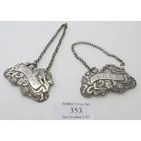 A pair of Victorian silver decanter labels 'Port' and 'Sherry', decorated with cherubs and bunches
