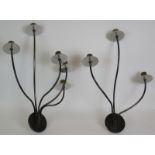 Four stylish steel and brass wall lights with varying sconces. (4). Largest: 68cm x 54cm.