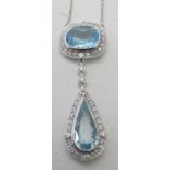 A fine 18ct white gold double pale blue topaz and diamond necklace. The cushion cut topaz is