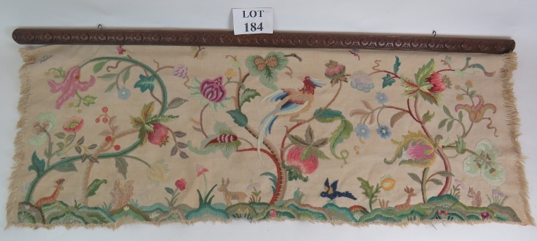 A handstitched wool work frieze panel in the Elizabethan style depicting a bird amongst stylised
