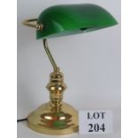 A contemporary brass merchant banker's desk lamp with green glass shade.