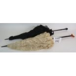 Two antique lace ladies parasols, one black and one cream. Longest 94cm. Both open and close