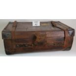 An antique leather travel trunk with wood slatted base and period labels. 82cm x 50cm x 30cm.