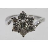 An 18ct white gold cluster ring, set with seven round brilliant cut diamond in the head and six