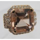 A large 18ct rose gold large cushion cut morganite, round brilliant cut and princess cut diamond