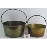 Two large heavy antique brass cooking pans with steel loop rivetted handles and good patina. Largest