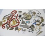 A large collection of costume jewellery to include cornelian necklace, a white metal pendant &