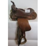 A vintage leather American Simco saddle with wooden stirrups stamped Simco 7100. Condition report: