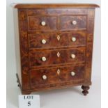 A 19th Century apprentice cabinet of 5 drawers with bird's eye maple veneer finish and turned bone