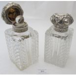 A pair of cut glass scent bottles with silver tops, London 1898, the silver tops embossed with