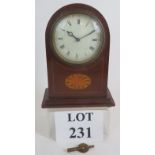 A small Edwardian inlaid mantel clock with French movement. Key present. Height 20cm. Condition