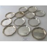 A set of 12 silver wavy edged coasters, approx 3" across, eleven Birmingham 1971, and one Birmingham