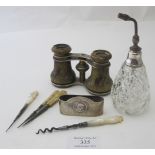 An assortment of items to include a pair of metal opera glasses, a silver fully hallmarked napkin