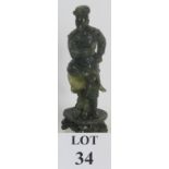 A carved Chinese green Jadeite/Hardstone figure of a male dancer, height 23.5cm, unsigned. Condition