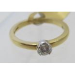 An 18ct yellow and white gold single stone diamond ring, diamond approx 0.18ct, size M. Condition