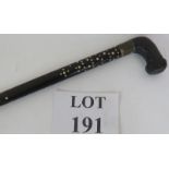 An Asian bone inlaid ebony walking cane with leather covered handle and barley twist shaft. Length