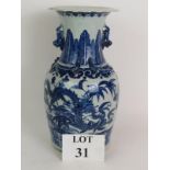 An antique blue and white Chinese porcelain vase decorated with four claw dragons and with applied