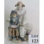 A large Nao porcelain figurine of a clown and boy. Height 30.5cm. Condition report: No issues.