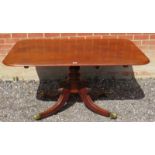 A Regency mahogany rectangular tilt top breakfast table, with a turned pedestal raised on four sabre