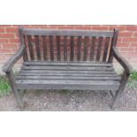 A vintage 2 seater slatted teak garden bench. Height 84cm. Width 119cm. Depth 55cm.