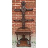 A 19th century oak hall stand heavily carved with roundels & Fleur de Les in the Flemish style, with